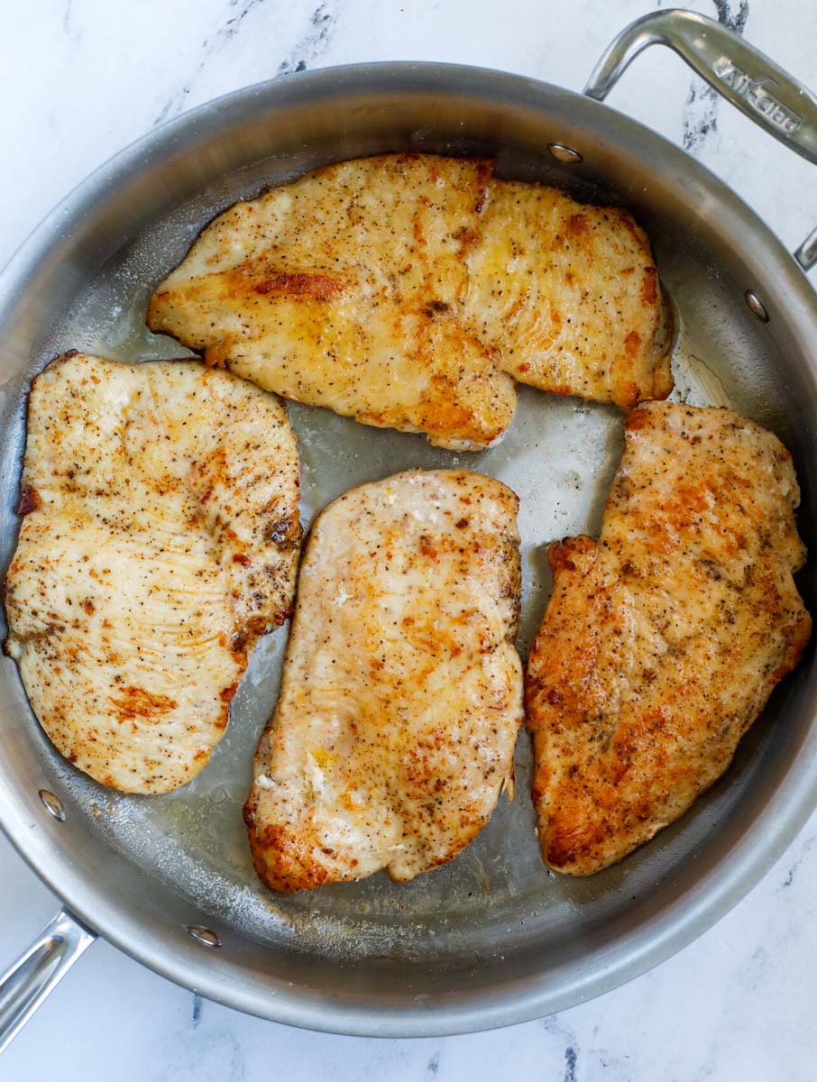 Pan frying chicken in a pot.