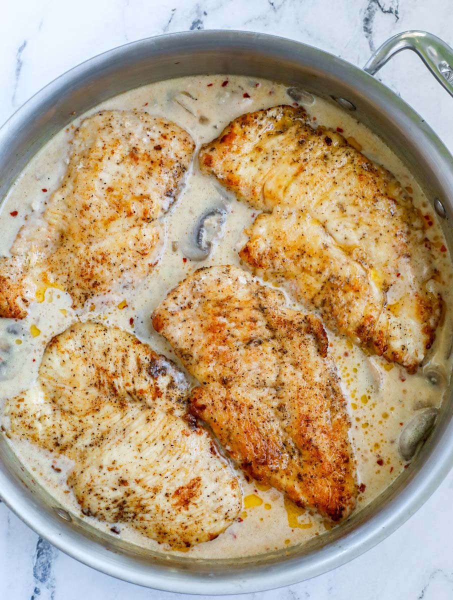 chicken placed into the creamy mushroom sauce.