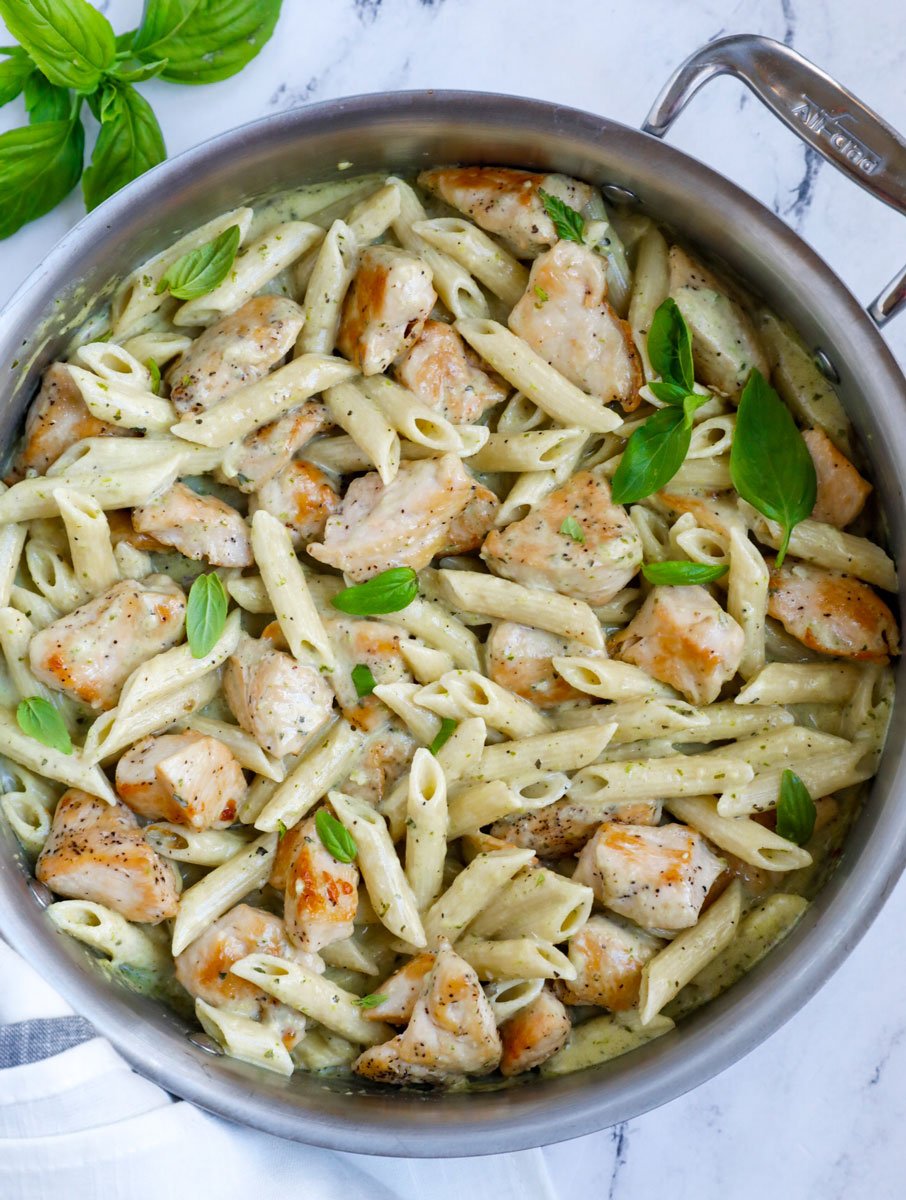 Creamy pesto chicken pasta in a pan.