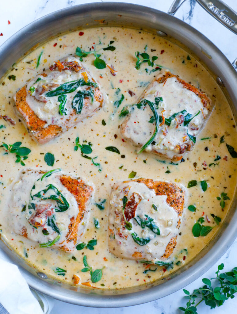 Top down view of creamy salmon in a silver pot. 