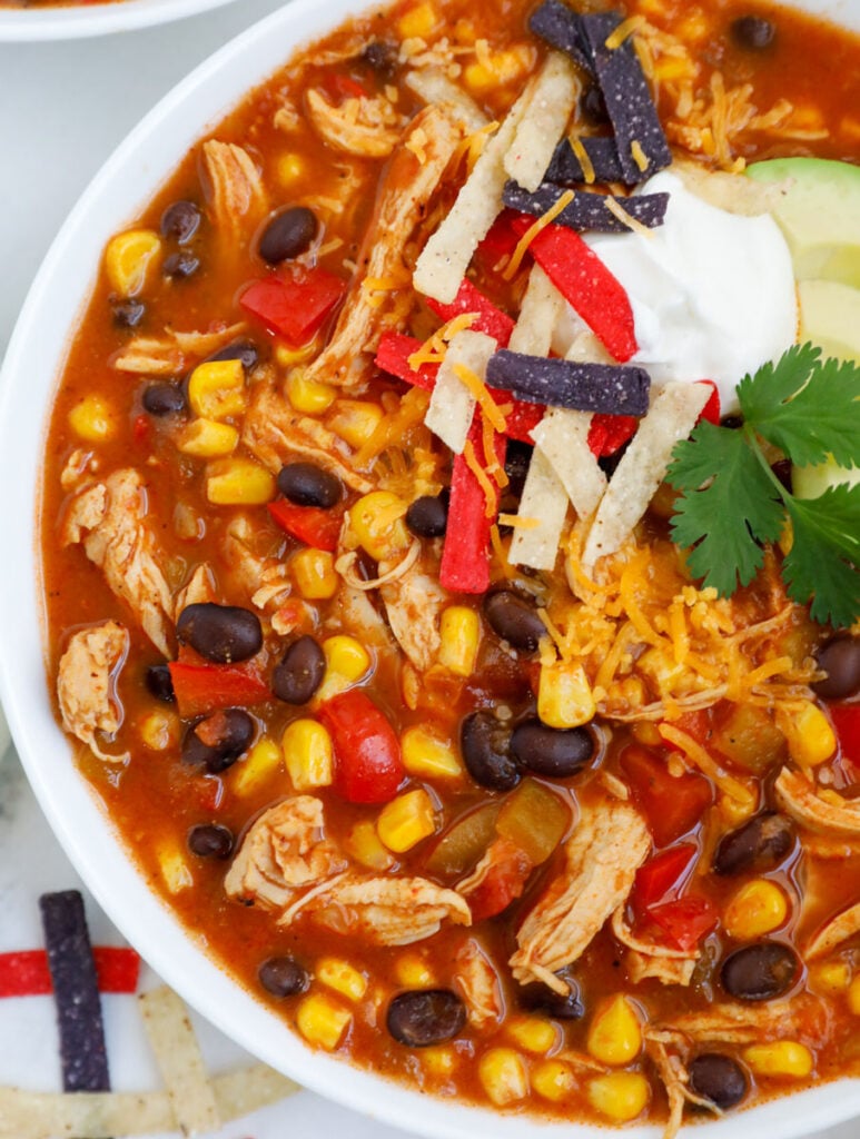 Close up of a bowl of creamy chicken enchilada soup.