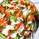Top down shot of chicken salad in a white bowl.