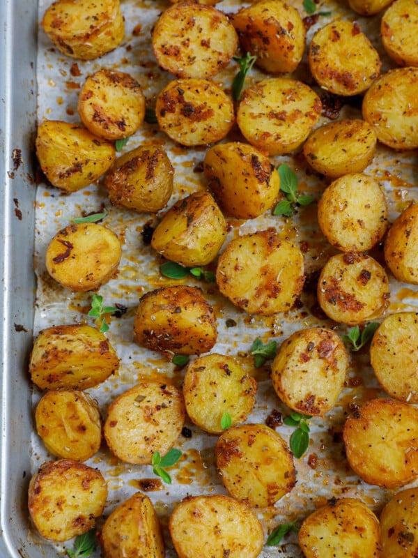 Top down shot of oven roasted baby potatoes on a sheet pan.