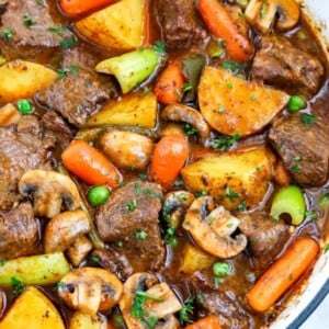 Overhead view of best beef stew in a big blue pot.