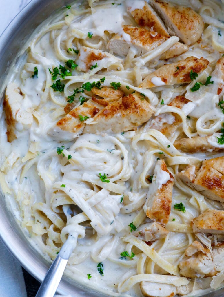 Top down shot of creamy chicken alfredo recipe in a pot.