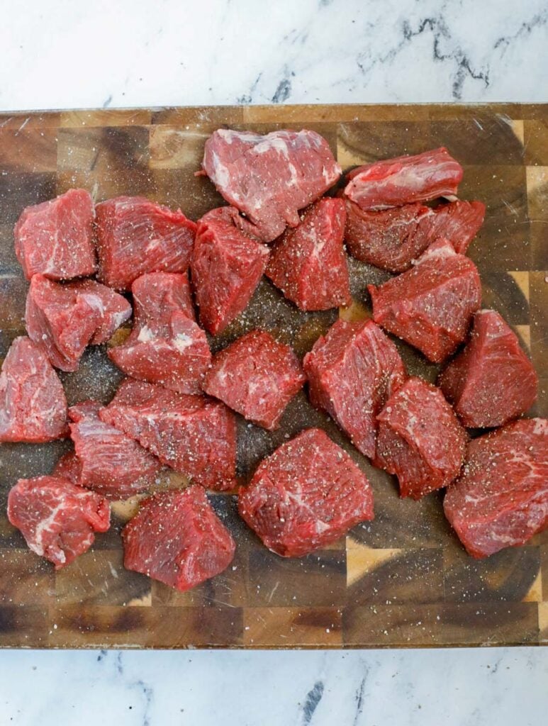 Chunks of beef on a table.