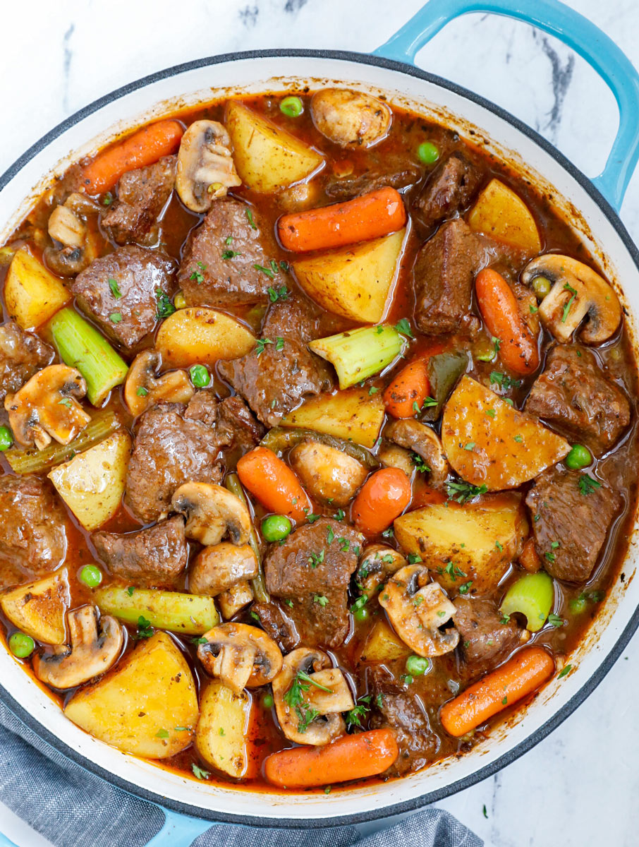 Top down view of best beef stew in a blue pot.