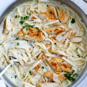 Top down shot of creamy chicken alfredo stirred in a pot.