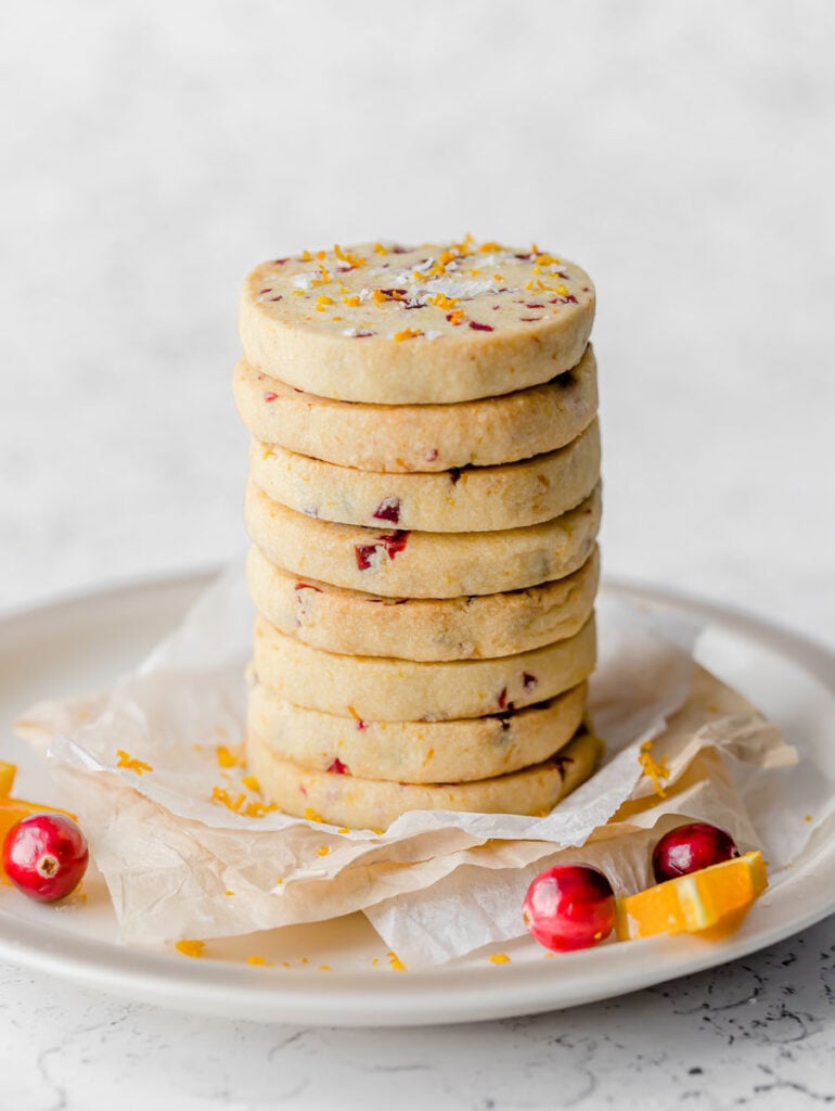 A tall stack of cranberry orange shortbread cookies. 