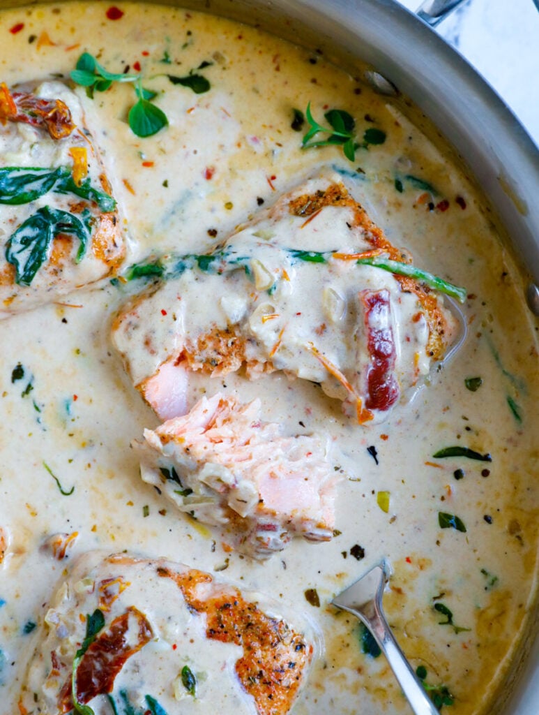 Overhead shot of creamy tuscan salmon in a skillet.