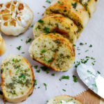 Slices of easy garlic bread on parchment.