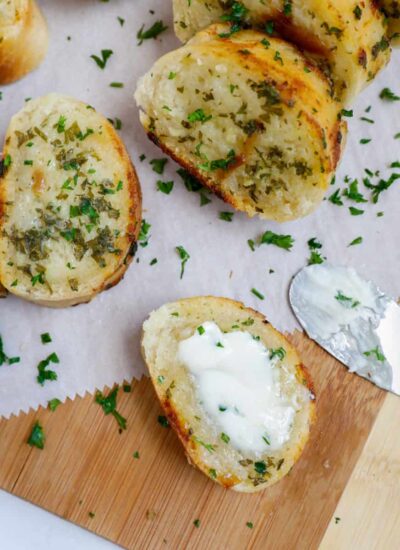 Top down shot of sliced easy garlic bread on parchment.