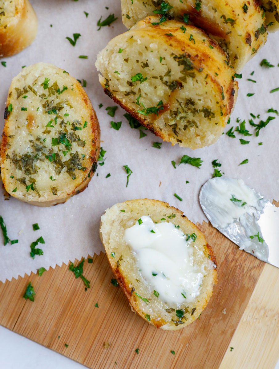 Top down shot of sliced easy garlic bread on parchment.