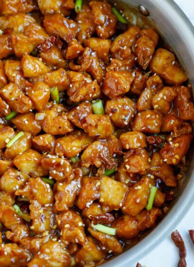 Close up of a skillet with bite sized pieces of general tso chicken.