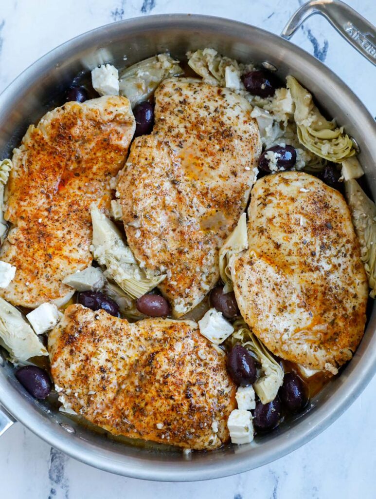 Chicken in a pot with olives.