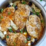 Top down shot of greek chicken in a skillet.