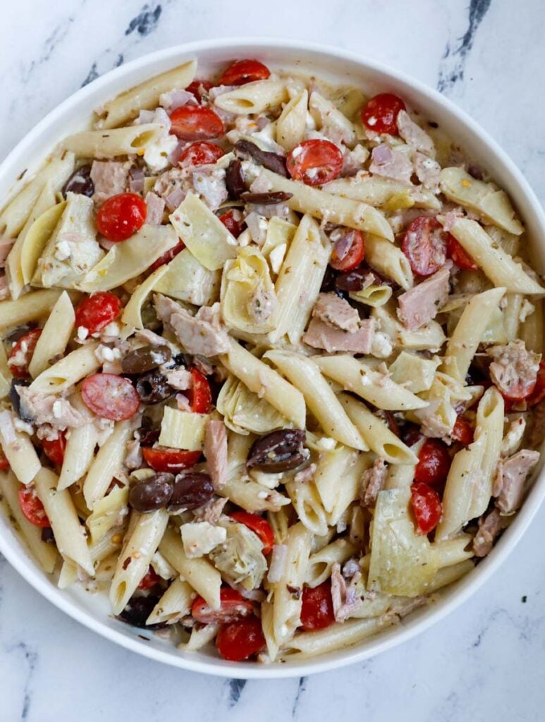 Top down shot of tuna pasta salad in a big bowl.