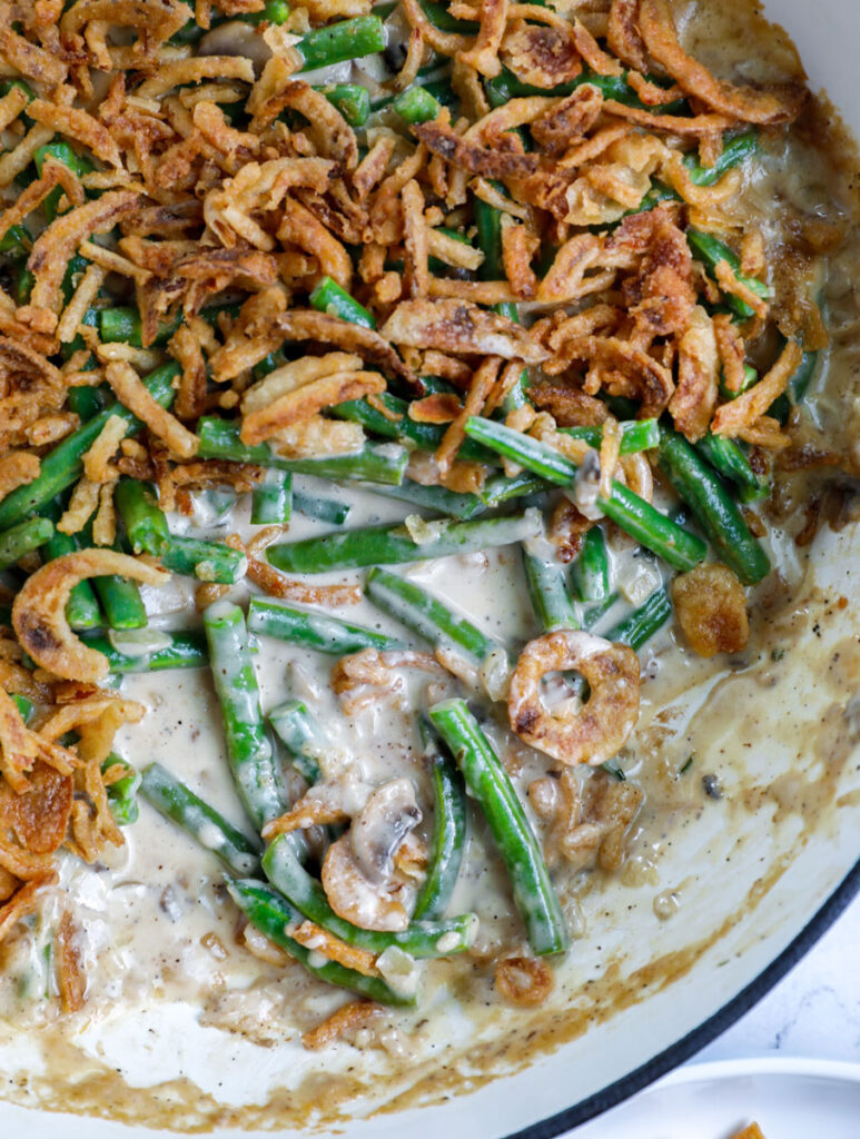 Overhead shot of some green bean casserole in a blue pot.
