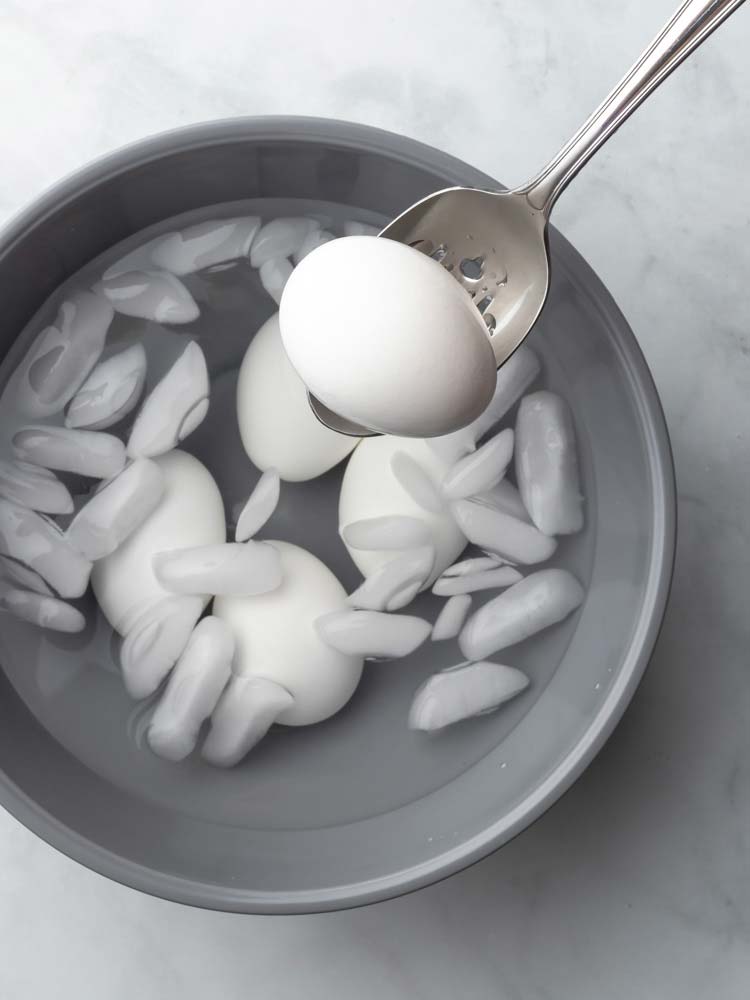 egg being taken out of the iced water
