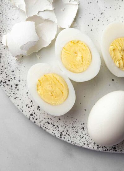 a hard boiled egg sliced in the middle showing the yolk.