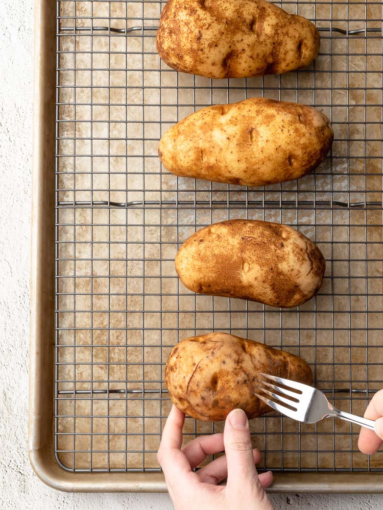 a fork being poked through a potato