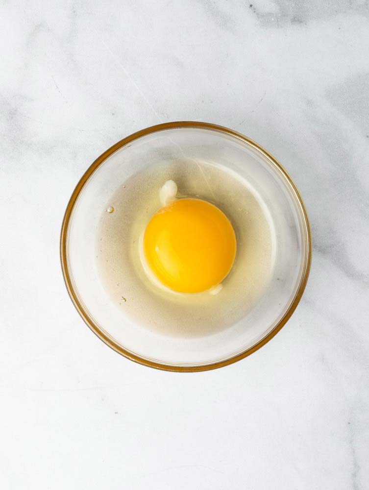 a cracked egg in a bowl