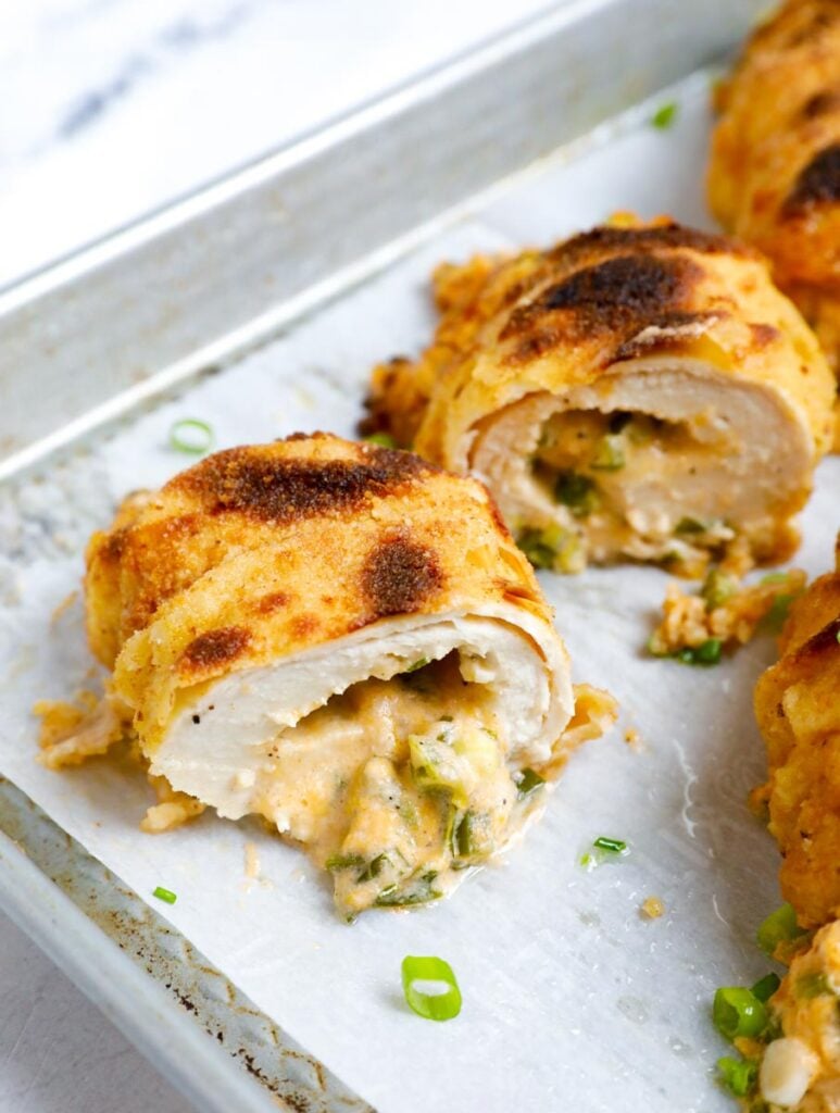 Jalapeno popper chicken, sliced on a baking sheet.