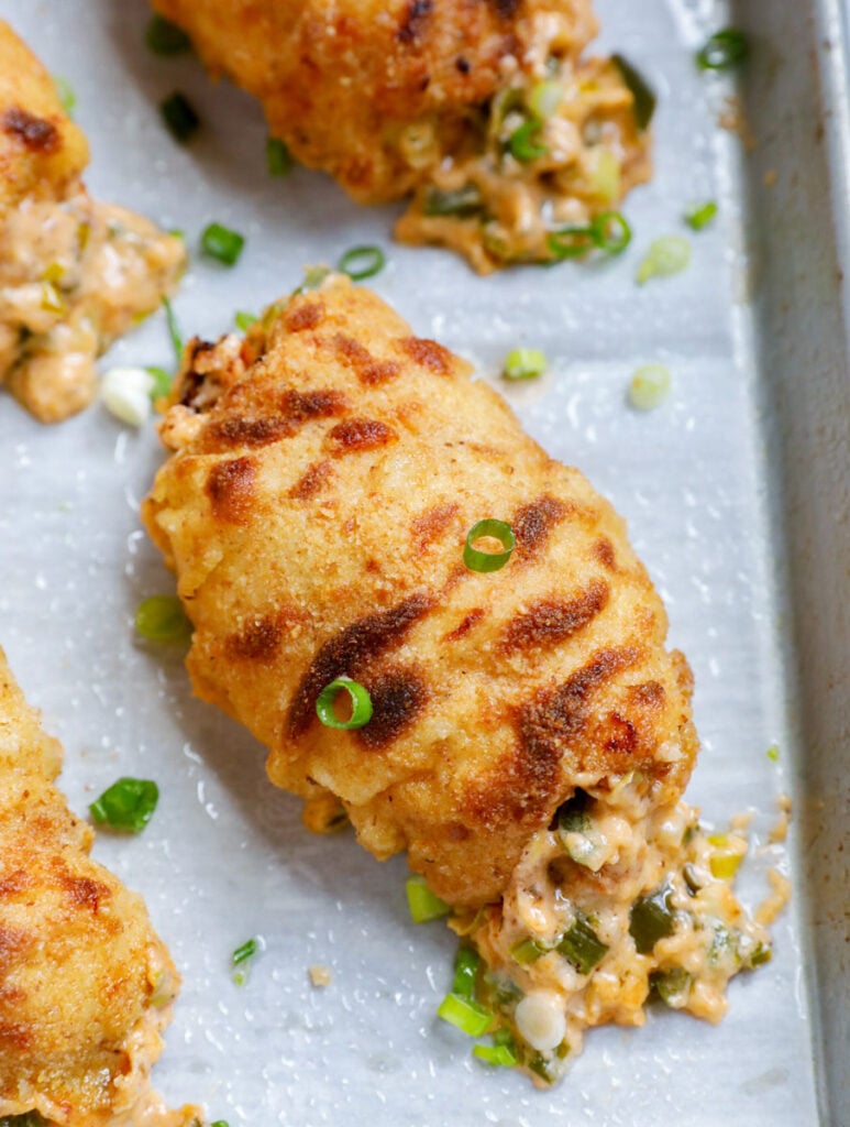 Overhead view of jalapeno popper chicken on a baking sheet. 