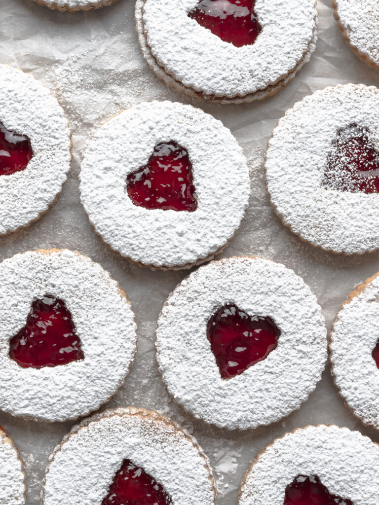 Overhead image of multiple assembled strawberry cookies.