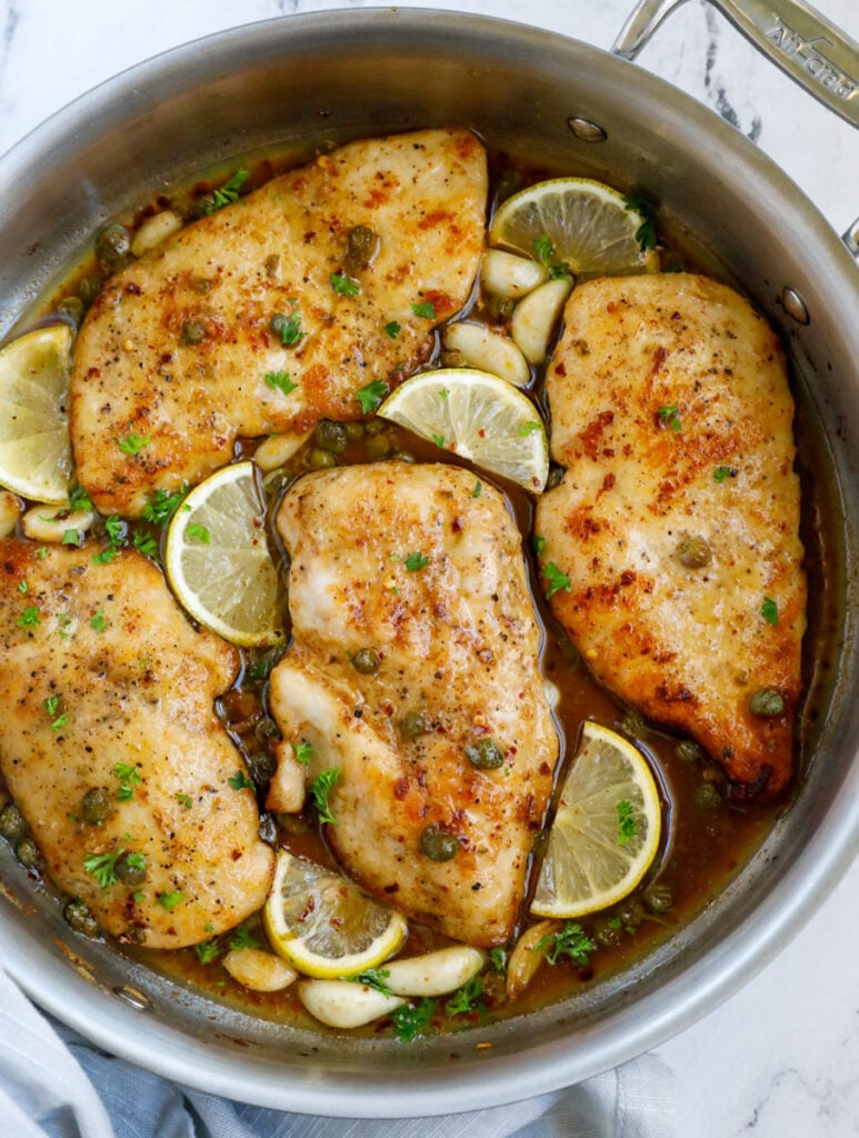 Top down view of lemon chicken piccata in a pot.