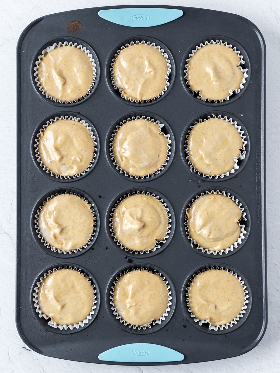 Top down shot of mini pumpkin cheesecakes in a mold. 