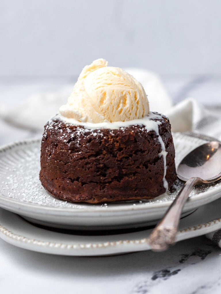 A chocolate molten lava cake with ice cream on top.