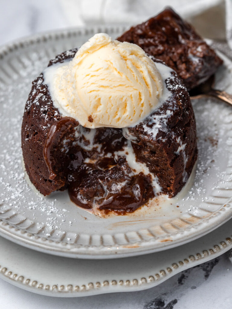 Molten cake with ice cream on top, cut opened.
