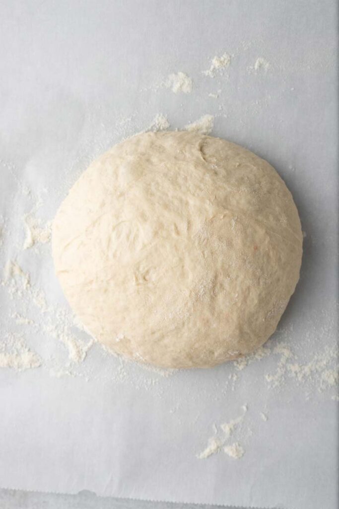 No knead bread dough, shaped into a boule.
