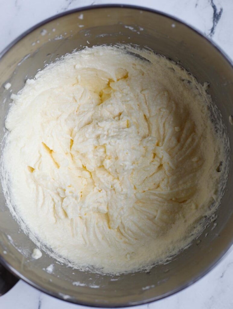 butter sugar and eggs whipped up in a bowl