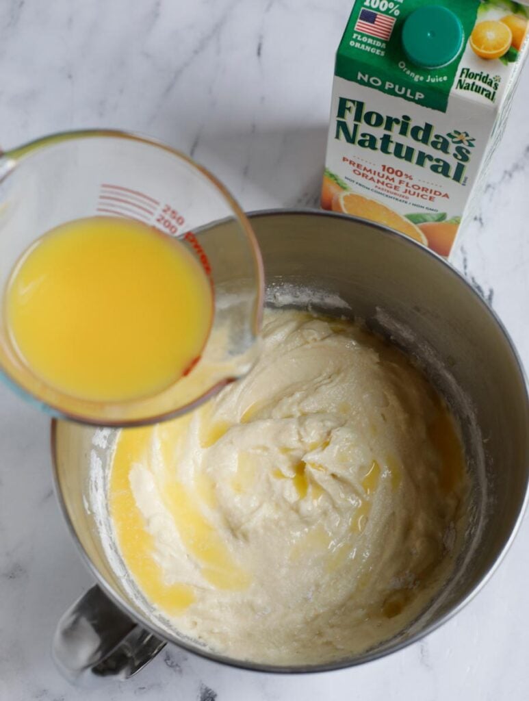 orange juice being added to the batter