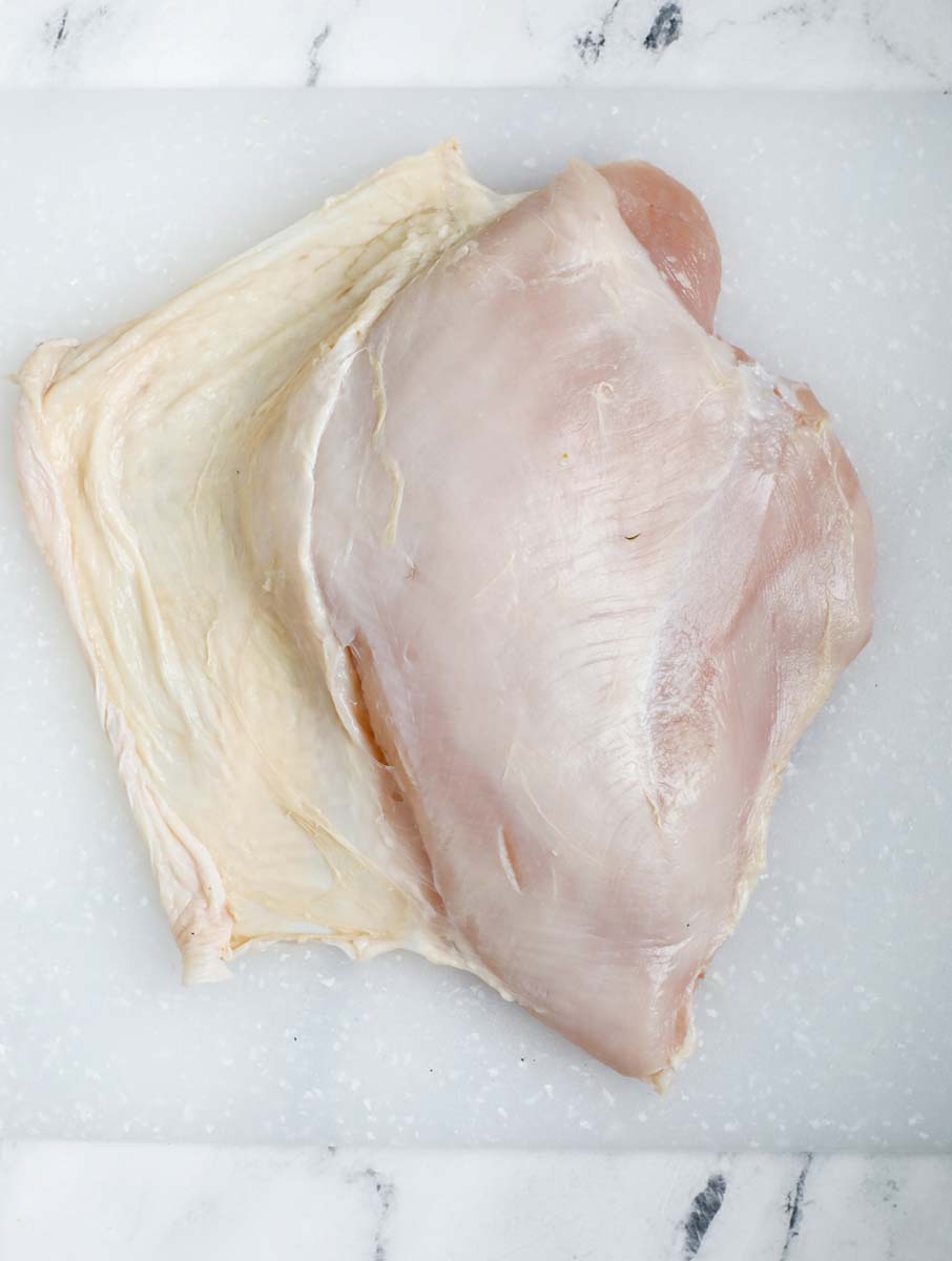 Lift up the skin of the breast without removing it completely off a turkey breast