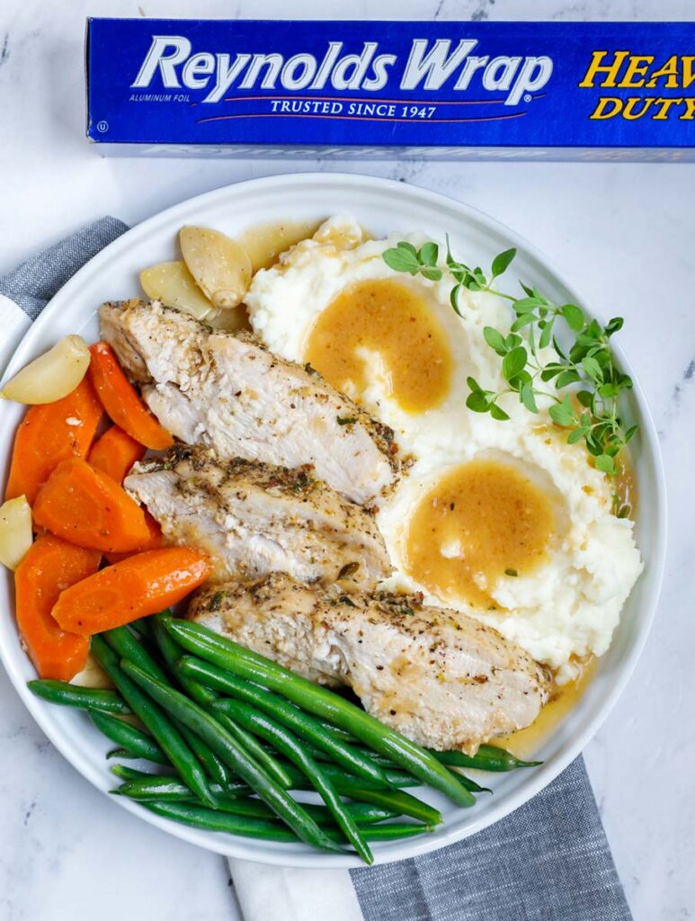 plate of turkey breast with vegetables and mashed potatoes