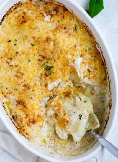 Top down shot of east potatoes gratin in a white dish.