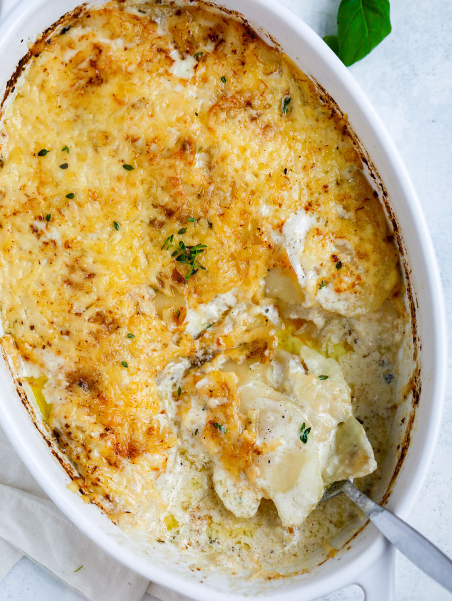 Top down shot of east potatoes gratin in a white dish.