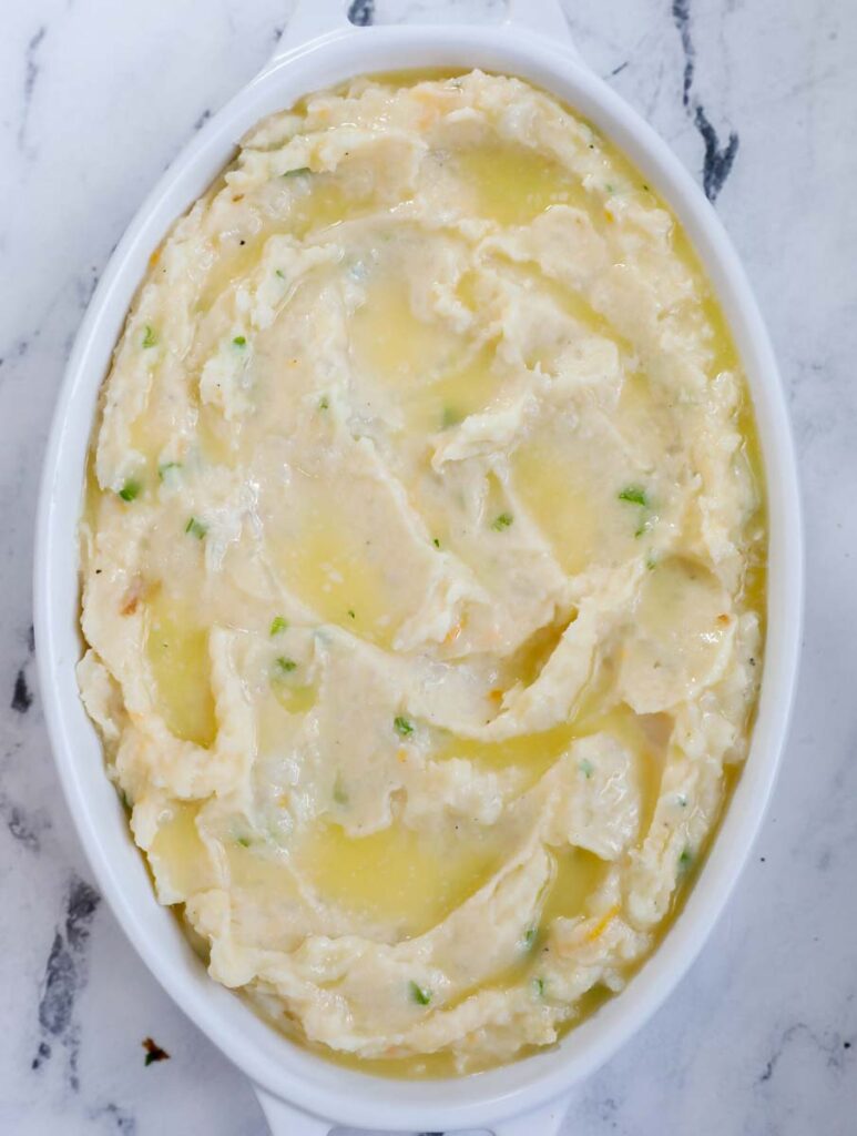 mashed potato in a baking dish with butter on top