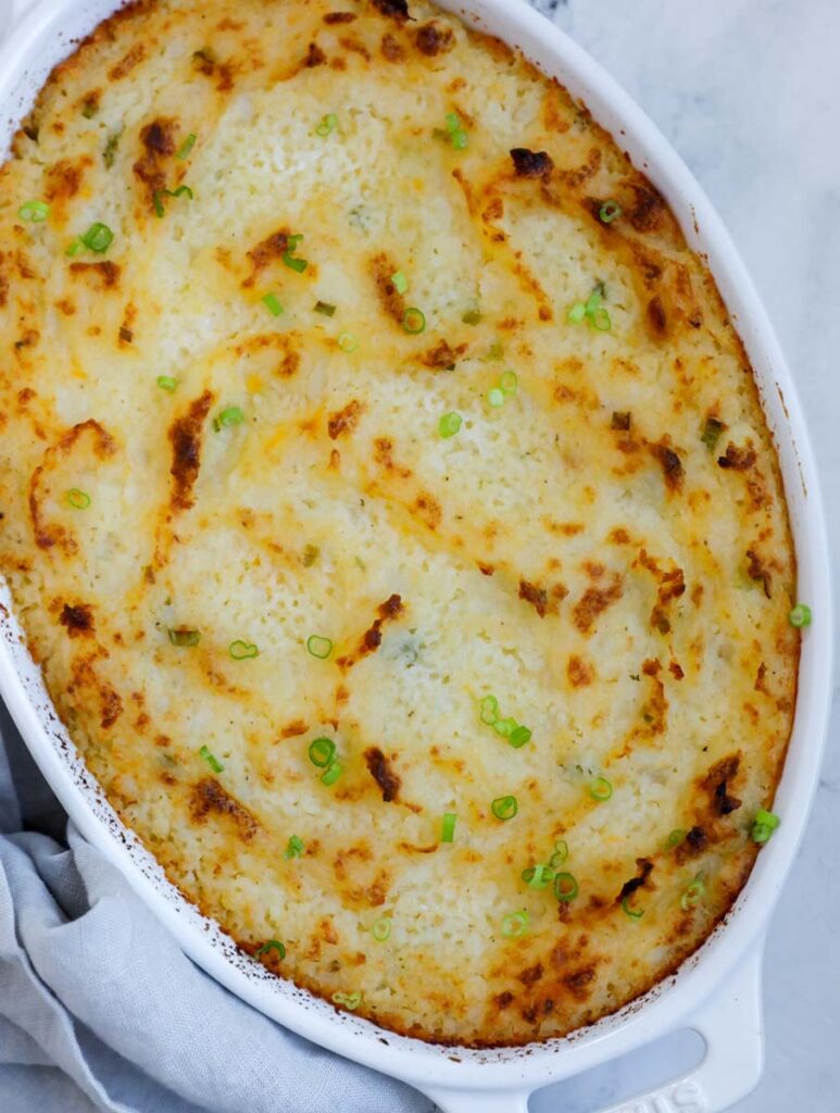 Top down shot of garlic mashed potatoes in a baking dish.