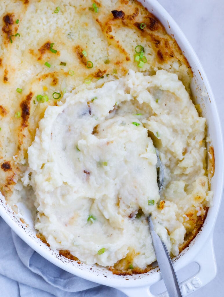 Top down view of garlic mashed potatoes in a dish.