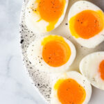 soft boiled eggs cut in half to show the runny yolk center