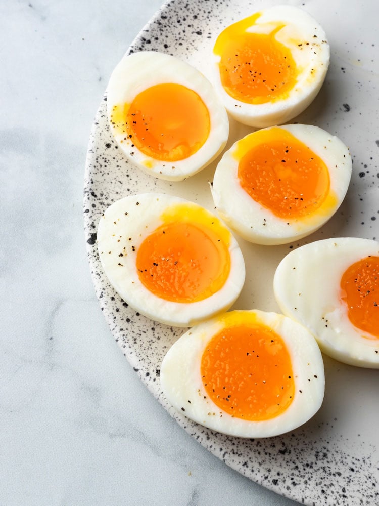 soft boiled eggs cut in half to show the runny yolk center