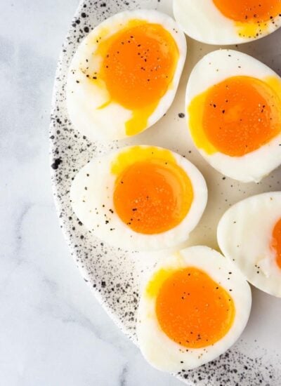 soft boiled eggs cut in half to show the runny yolk center
