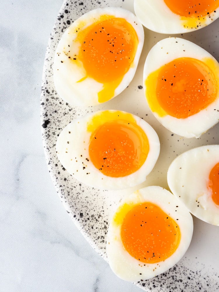 soft boiled eggs cut in half to show the runny yolk center