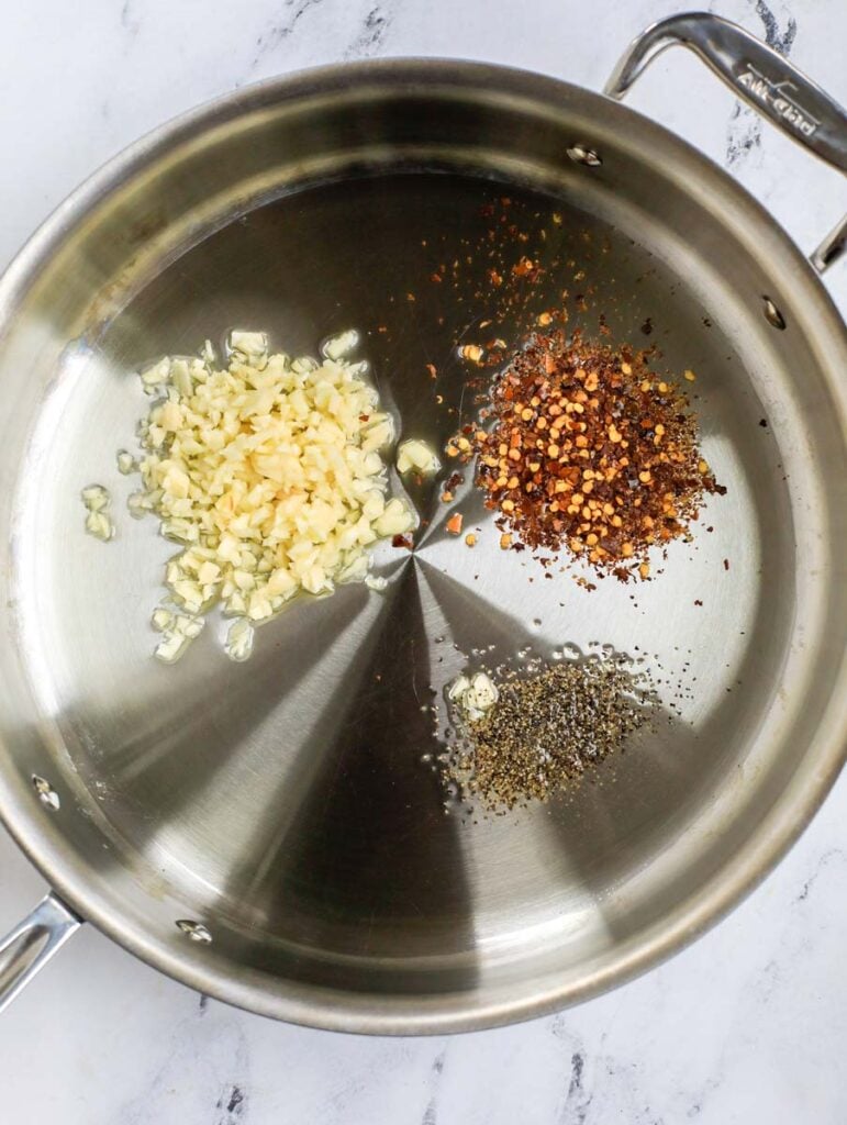 Top down shot of garlic, pepper and chili flakes.