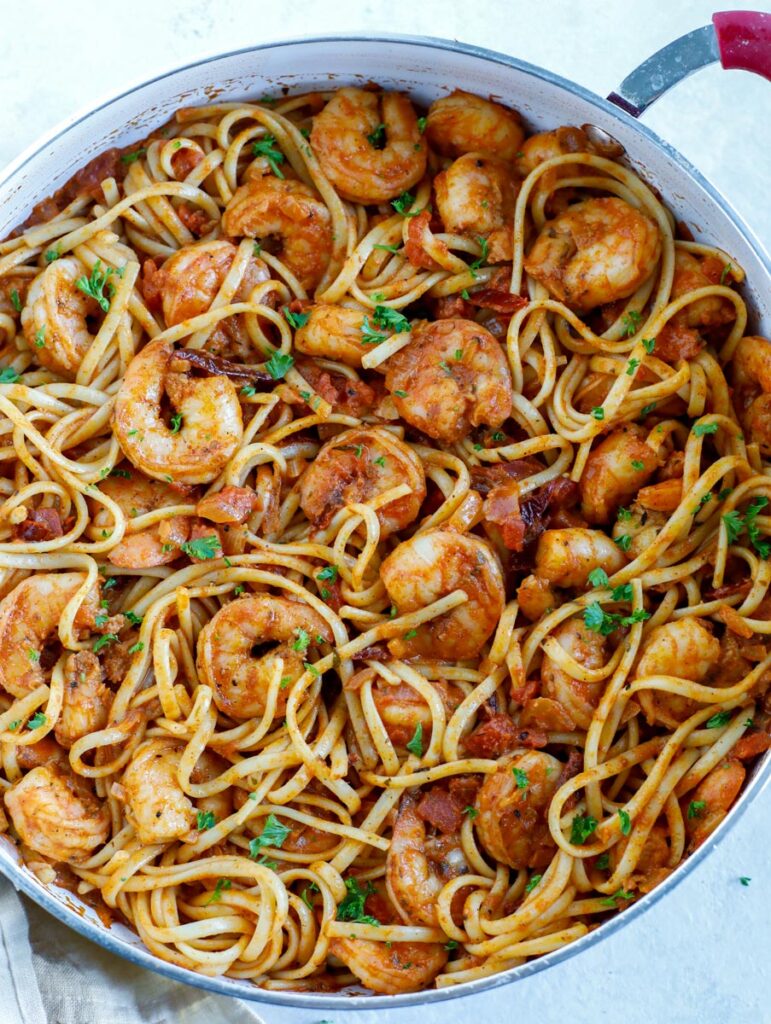 Top down shot of shrimp pasta in a skillet. 