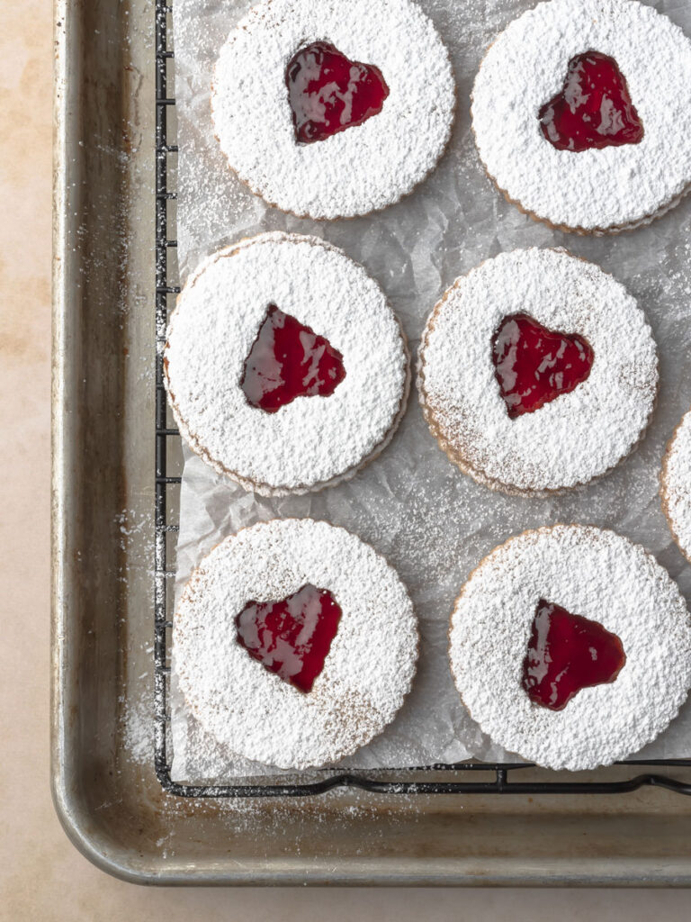 Close up of assembled strawberry jam linzer cookies.